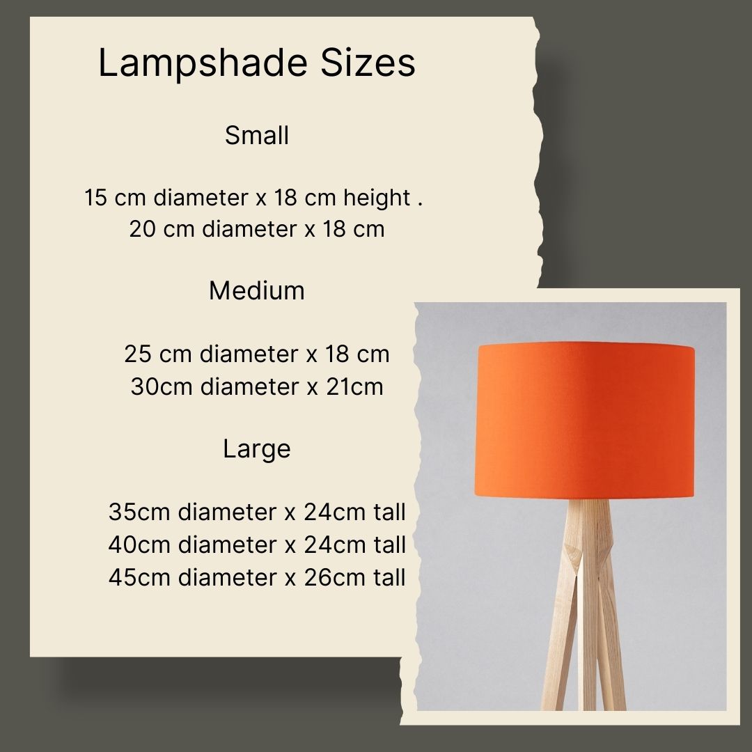 Vibrant orange cylindrical table lamp with smooth fabric shade on a light wooden tripod base, not a sage green lampshade