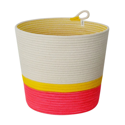 A cylindrical woven planter basket made of 100 percent cotton rope in white yellow and pink color blocks