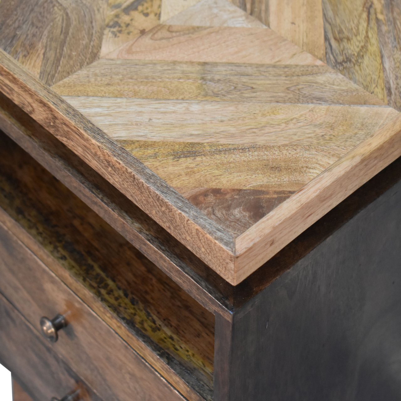 Platform bedside table with rustic geometric multi toned reclaimed wood top and dark metal base for bedside use