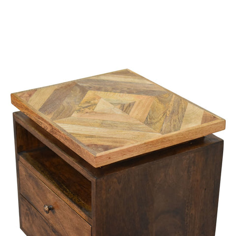 Rustic wooden platform bedside table with geometric chevron-patterned reclaimed wood top and single metal-knob drawer