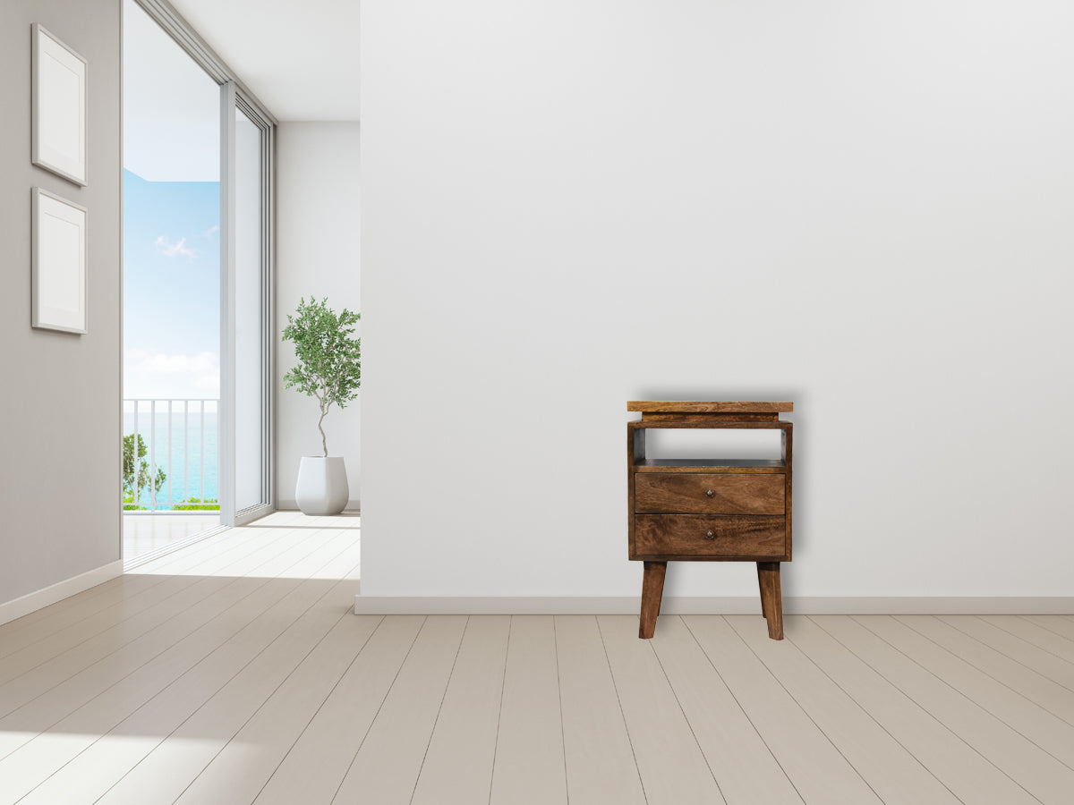 A rustic platform bedside table with two drawers tapered legs and natural wood finish for bedroom use