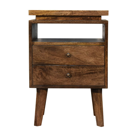 A rustic wooden platform bedside table with two drawers, a top shelf, and tapered legs for bedroom storage