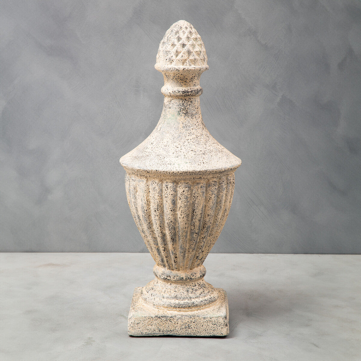 Plato light stone effect urn with weathered off-white stone effect and diamond-patterned pinecone finial top