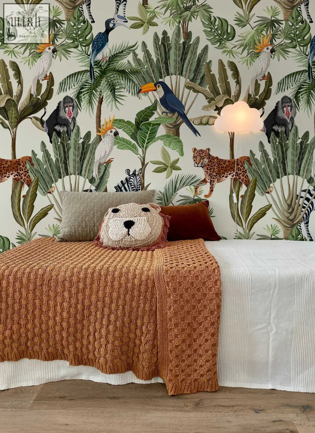 A cozy orange knitted lion pillow with a soft plush face and embroidered nose for playful jungle animals nursery decor