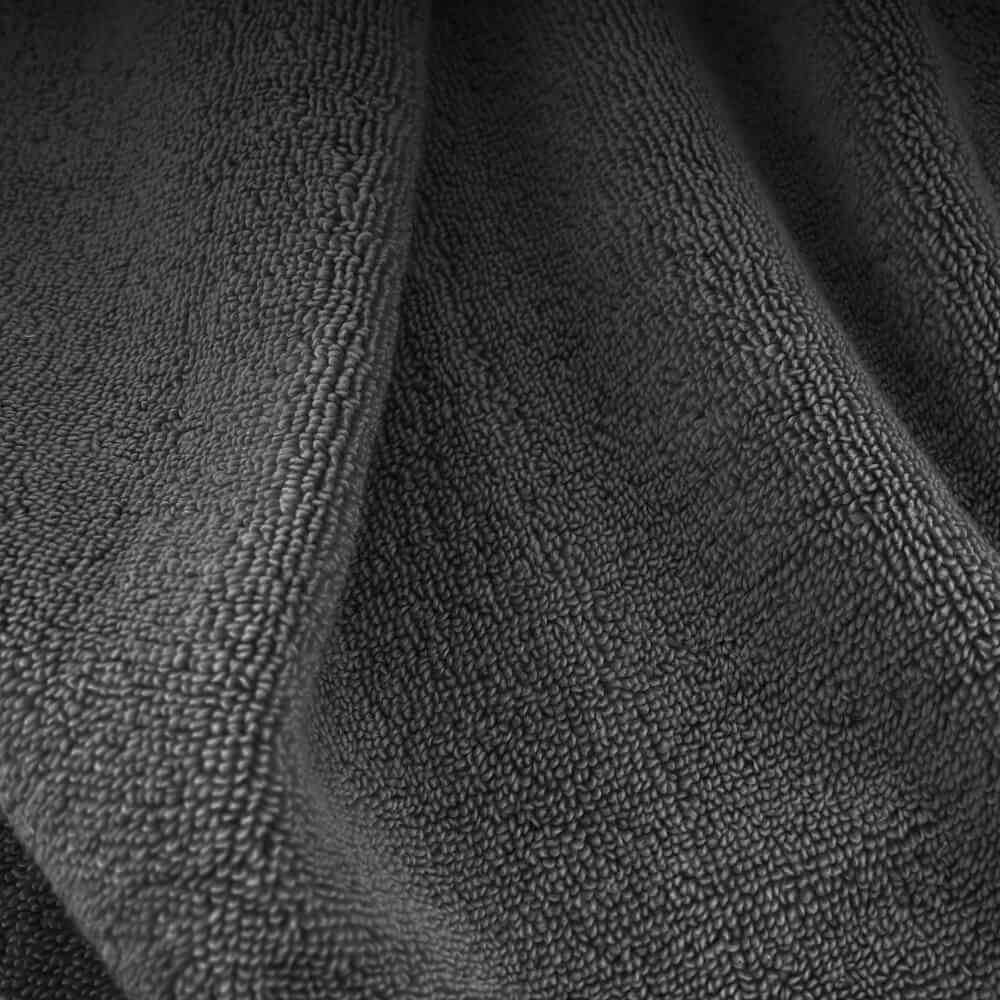 Dark gray plush towels with a soft textured surface perfect for cozy bathroom use
