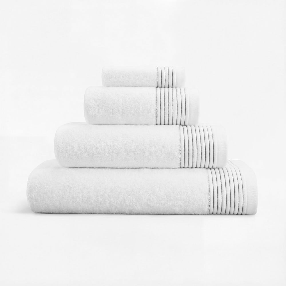 Plush towels made of white cotton with soft ribbed gray trim for a cozy bath experience