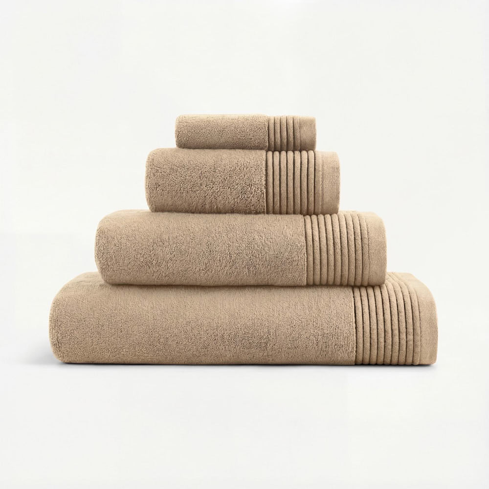Stack of beige plush towels set with ribbed edges soft and absorbent towels set perfect for bathroom use