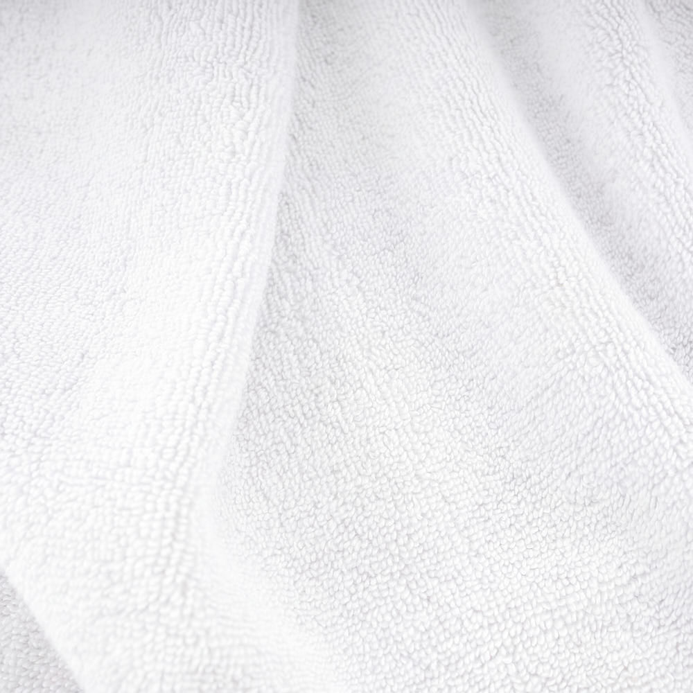 White plush towels set with a soft textured surface perfect for cozy bath time and everyday use