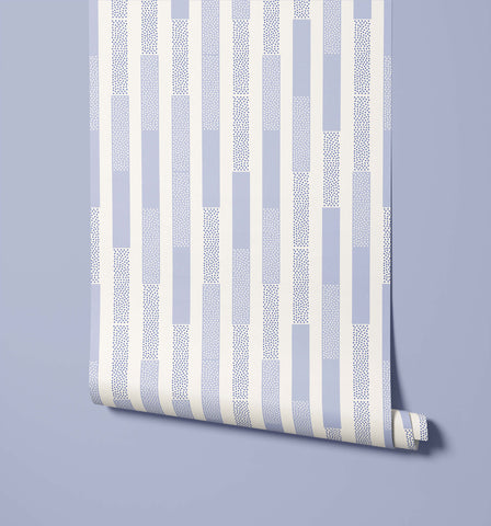 A roll of polka wallpaper with light blue and white stripes and dotted patterns perfect for room decor