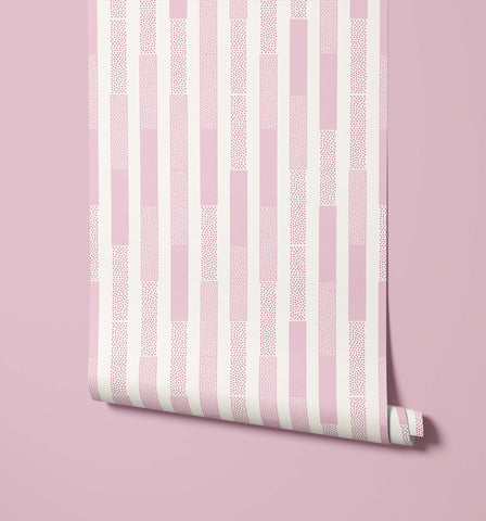 A roll of polka wallpaper with pink and white stripes and a dotted texture pattern for wall decor