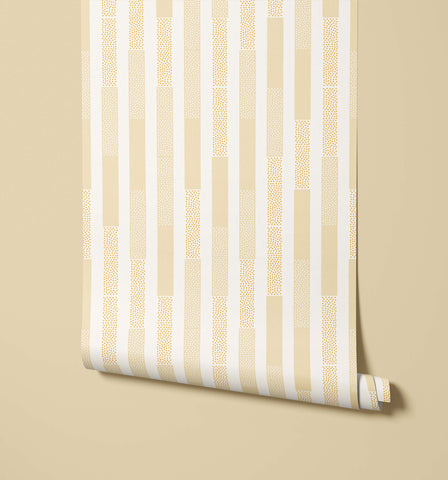 A roll of polka wallpaper with beige and white stripes and a subtle dotted texture perfect for home decor