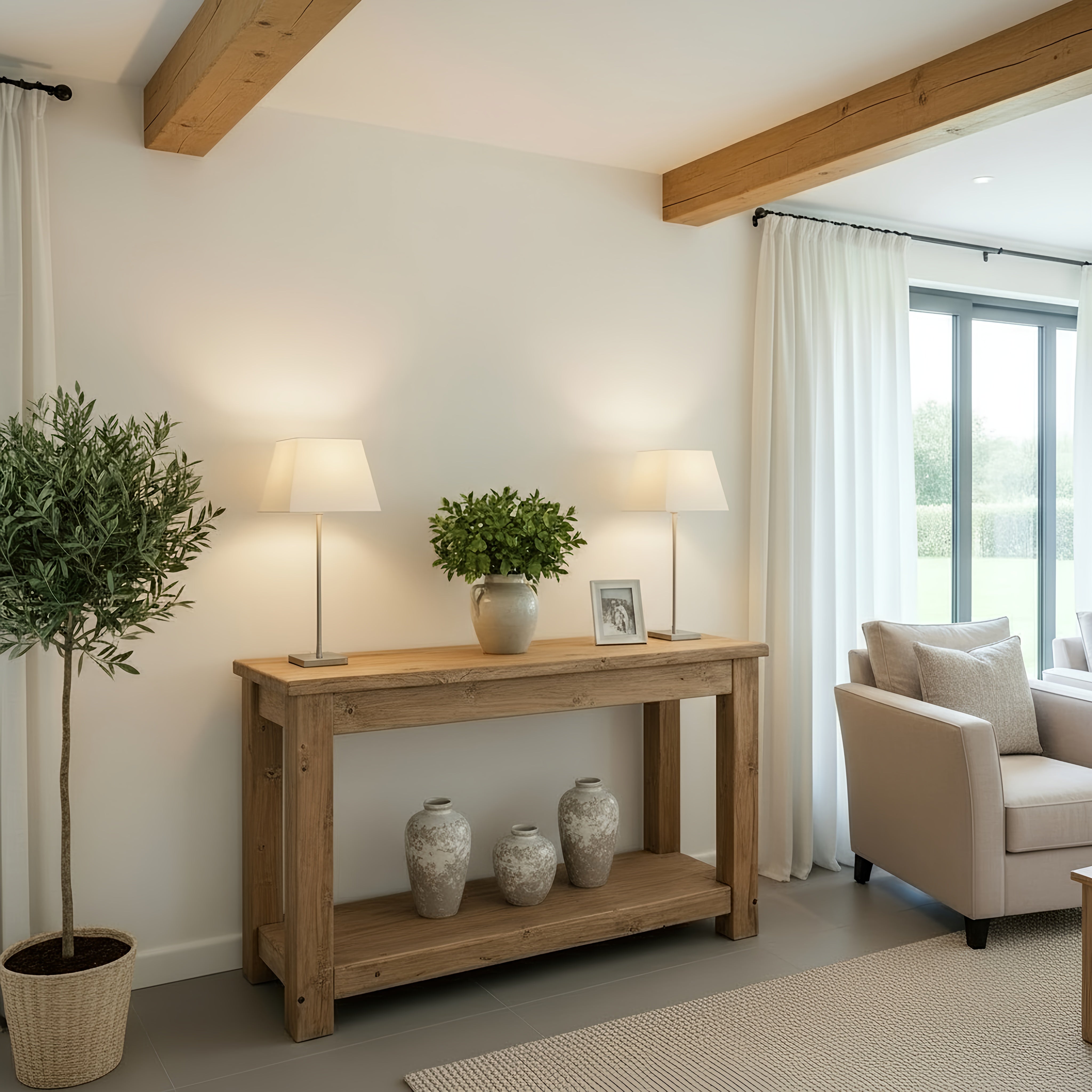 Polo solid wood console table in light wood with a lower shelf holding three gray vases and two matching lamps