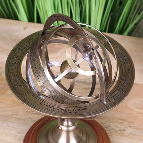 Antique brass armillary sphere with engraved markings on a wooden base ponnur large brass armillary sphere 30cm