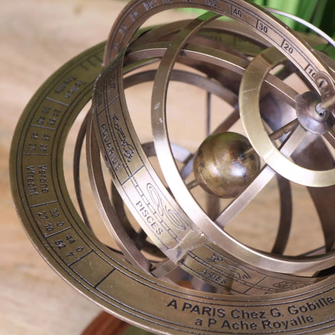 Antique brass armillary sphere with engraved zodiac signs and degree markings in a 30cm large celestial globe design
