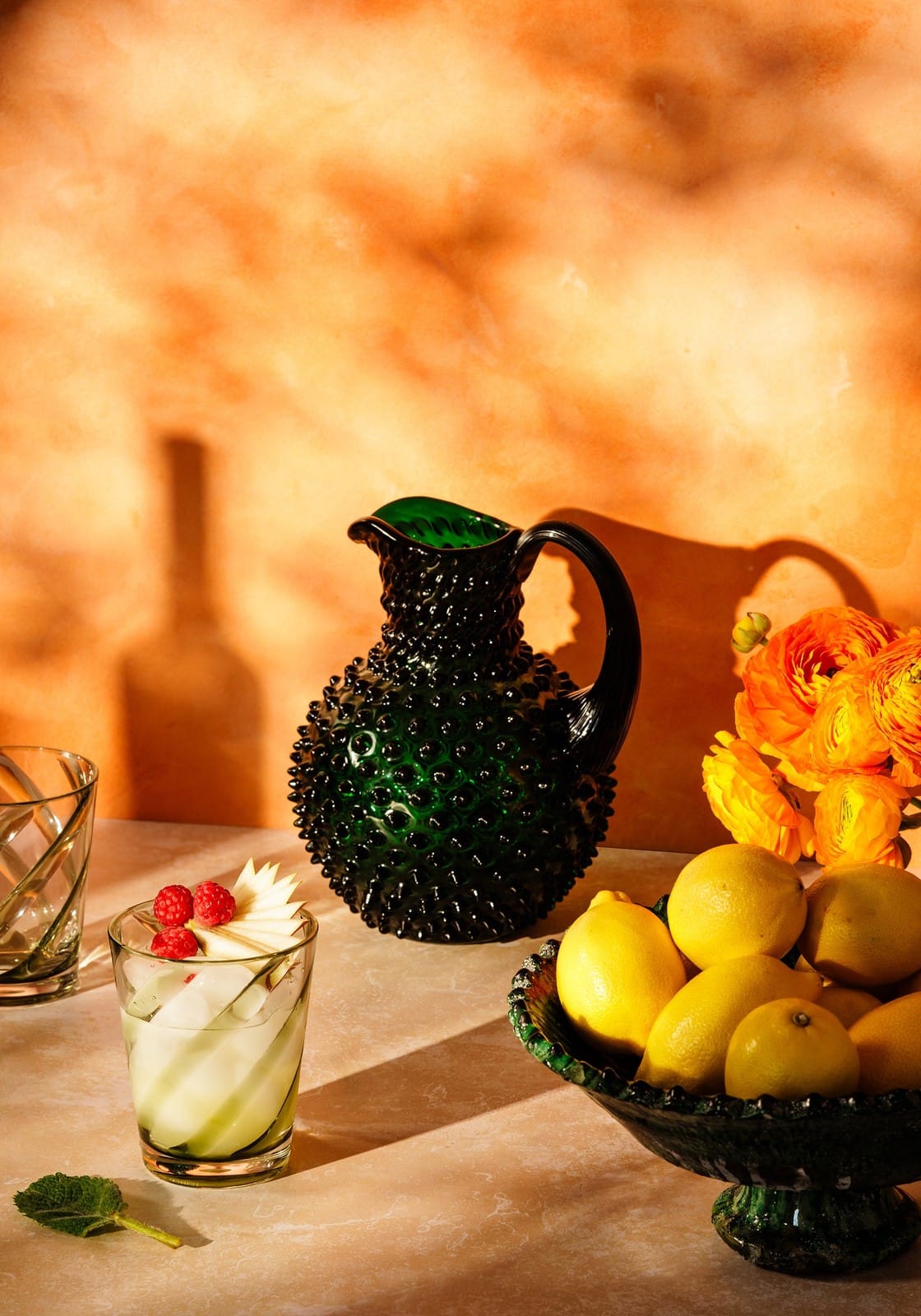 A dark green textured glass pitcher with a glossy finish and curved handle for poolside gossip green acrylic set