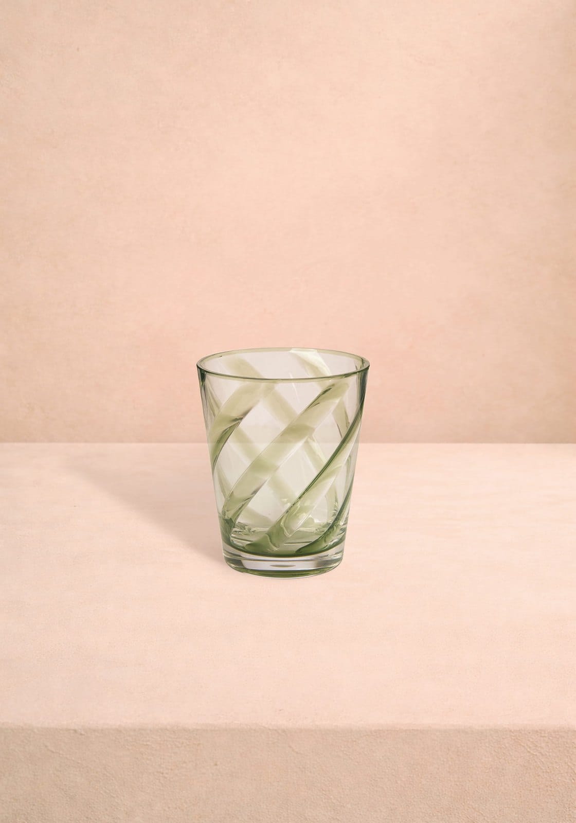 A translucent sage green acrylic tumbler with a swirling geometric lattice pattern from poolside gossip set of 6