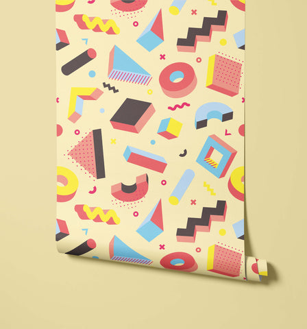 Pop pillow with vibrant geometric pattern in bold red blue yellow and black on pale cream background