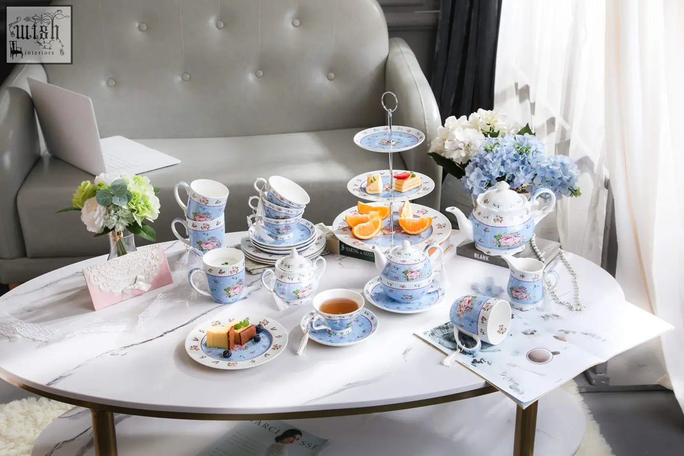 A delicate blue and white porcelain teapot sugar bowl set with floral patterns including cups saucers and a tiered stand