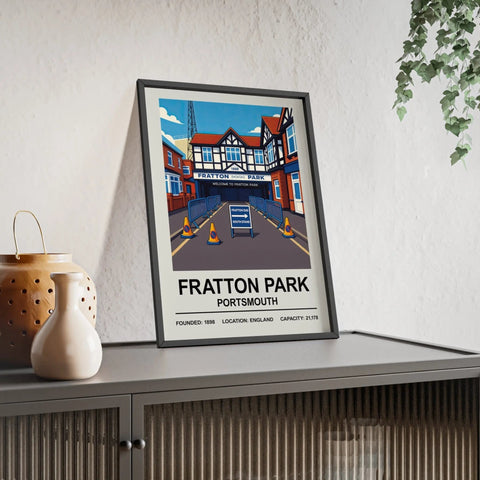 Framed poster of fratton park portsmouth with vibrant illustration and bold typography in a black frame