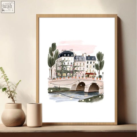 A framed pastel pink and green parisian bridge watercolor in a light wood frame from poster art london set of 3