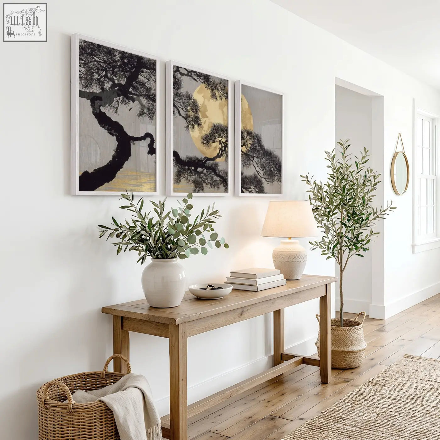 Minimalist wooden console table with natural finish and clean lines below japanese pine tree and moon wall art prints set of 3