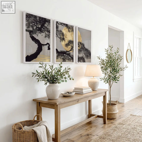 Minimalist wooden console table with natural finish and clean lines below japanese pine tree and moon wall art prints set of 3