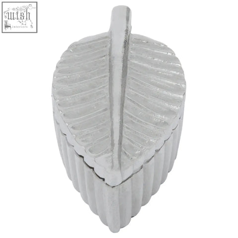 Silver plume box shaped like a leaf with a ribbed textured surface and central ridge in prato silver finish