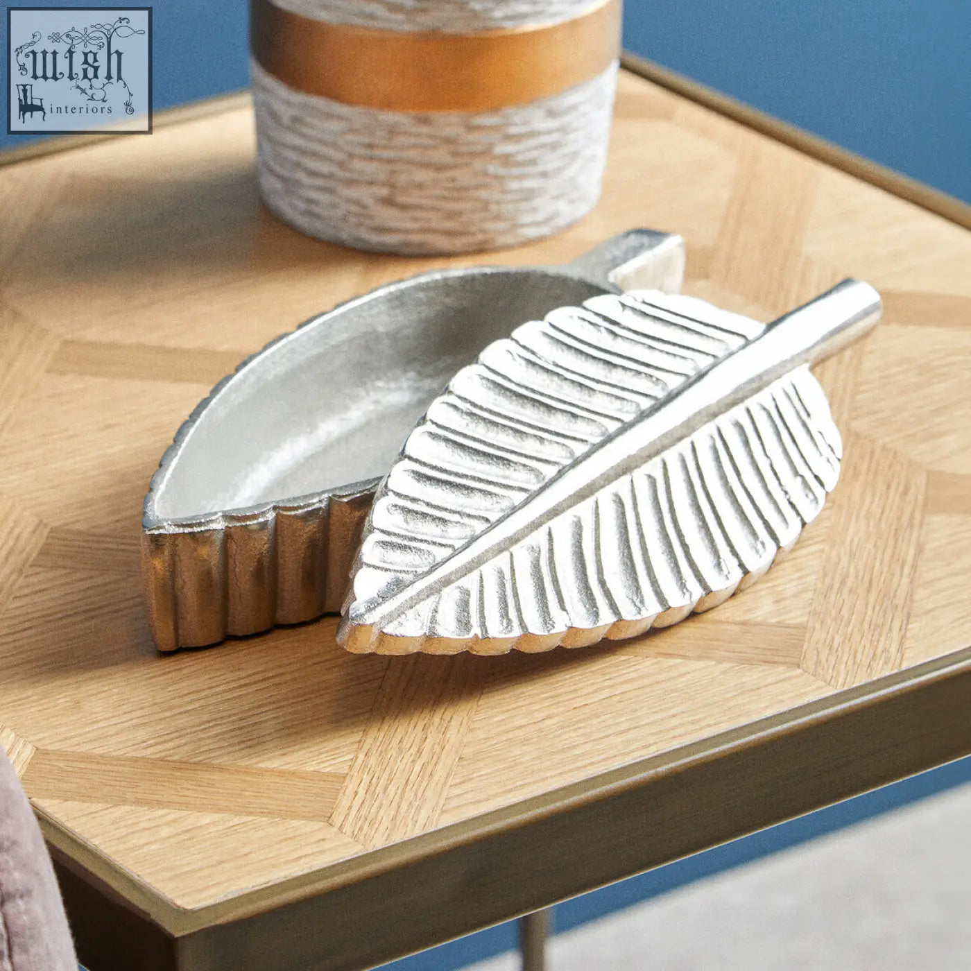 Silver plume box tray shaped like a silver leaf with textured metallic finish and gold-toned edges in prato design