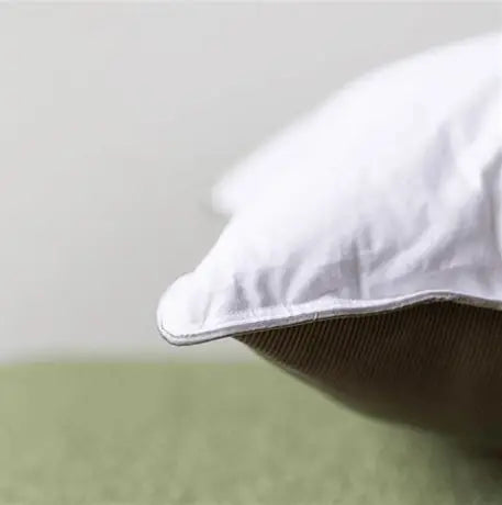 White premium hypoallergenic microfibre pillow with soft quilted cover and neatly stitched edges for all sleep positions