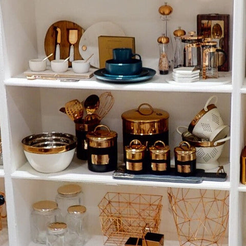 Prescott charcoal copper sugar canister set featuring gold-accented black ceramic with matching lids on a shelf