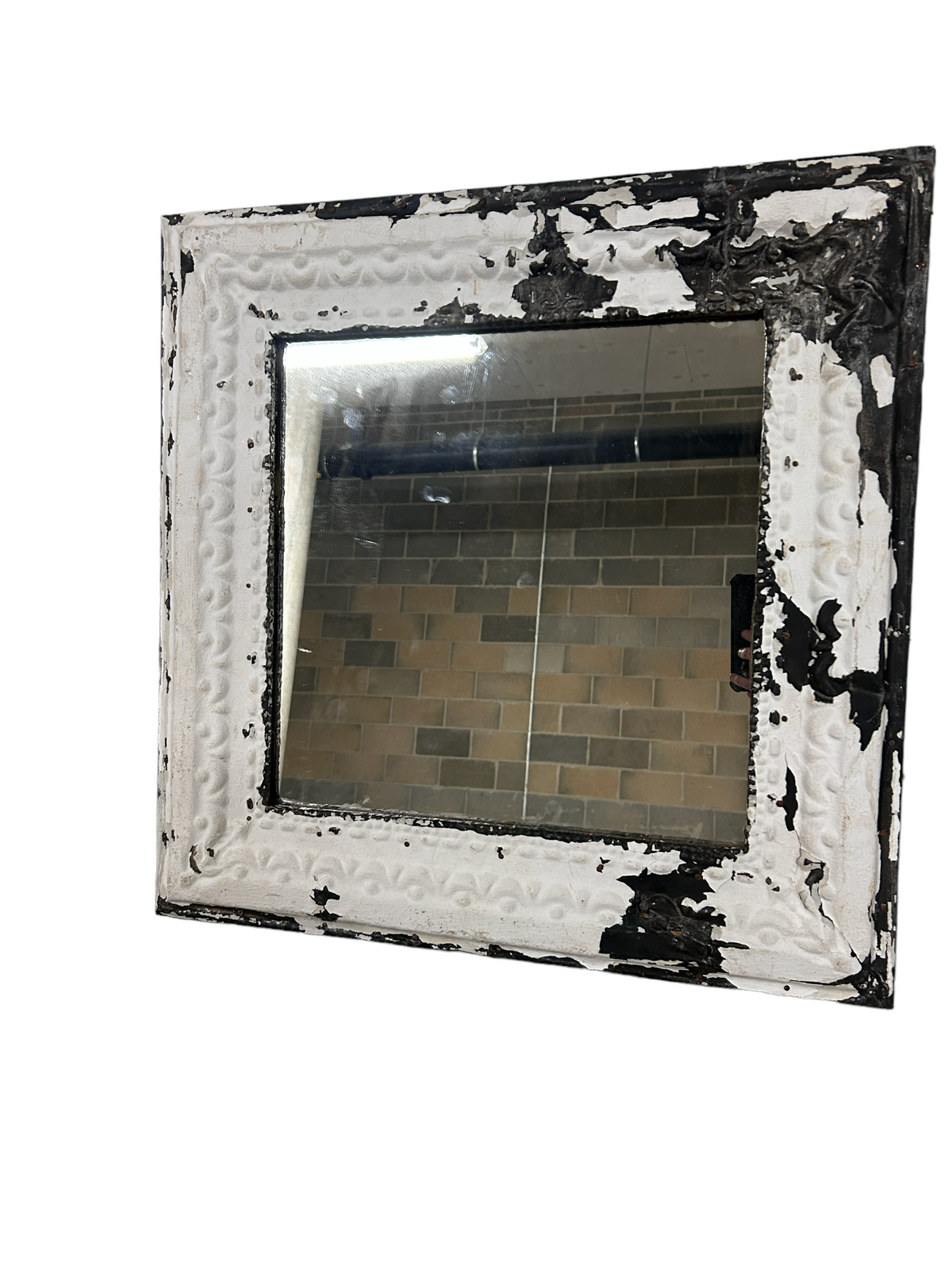 Distressed white and black pressed tin ceiling tile mirror with chipped paint revealing dark metal underneath