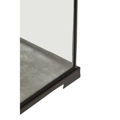 Black-framed glass shower door with sleek modern design paired with small antique black lantern style