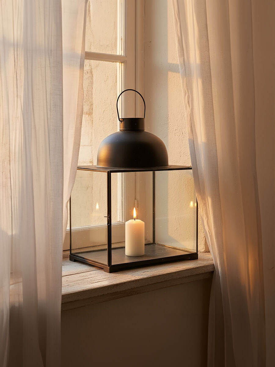 Preston small antique black lantern with clear glass panels and a lit white candle inside