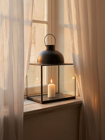 Preston small antique black lantern with clear glass panels and a lit white candle inside