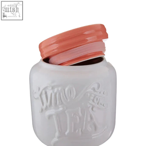 White ceramic mason jar style tea canister with coral lid and embossed since tea lettering from pretty things tea