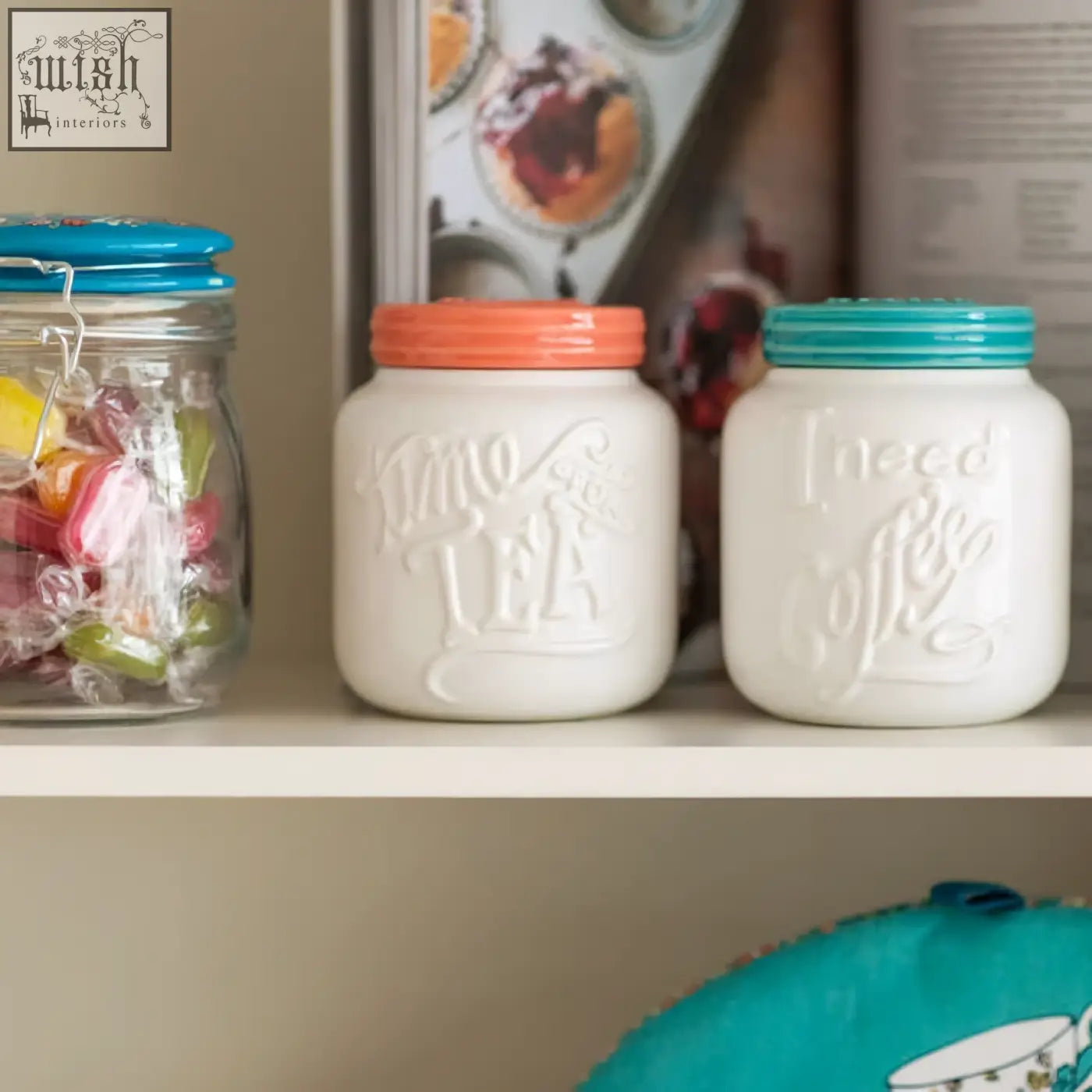 White ceramic pretty things tea canister set with teal and orange lids embossed with i need tea and i need coffee