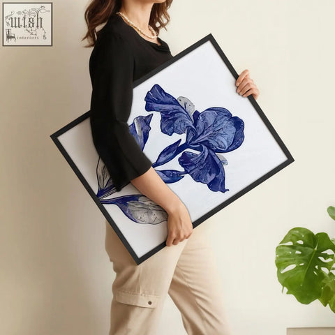 A framed botanical wall art print featuring a detailed blue iris illustration on white for bathroom decor