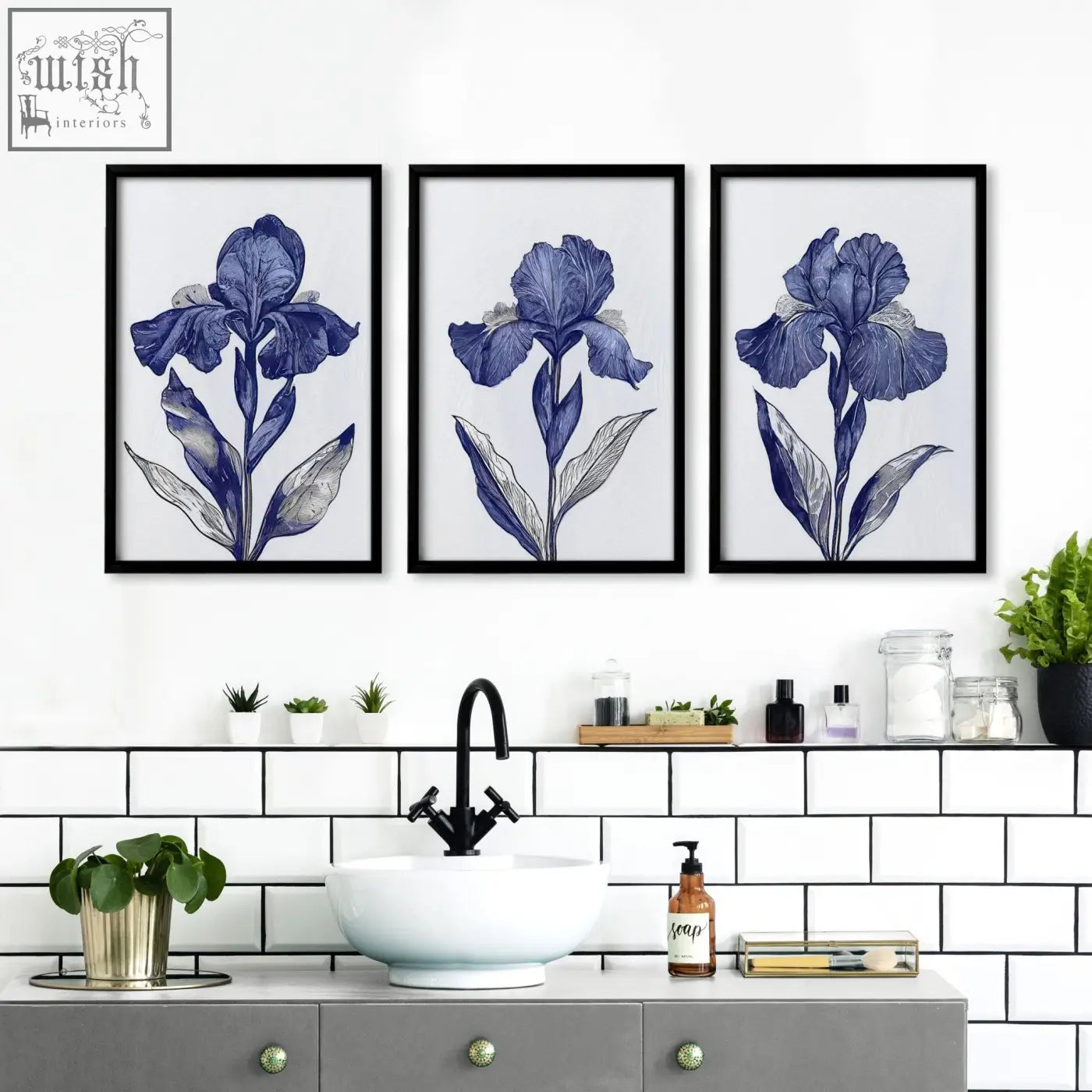 Three framed blue iris botanical wall art prints in black frames hang above a bathroom sink as wall art prints