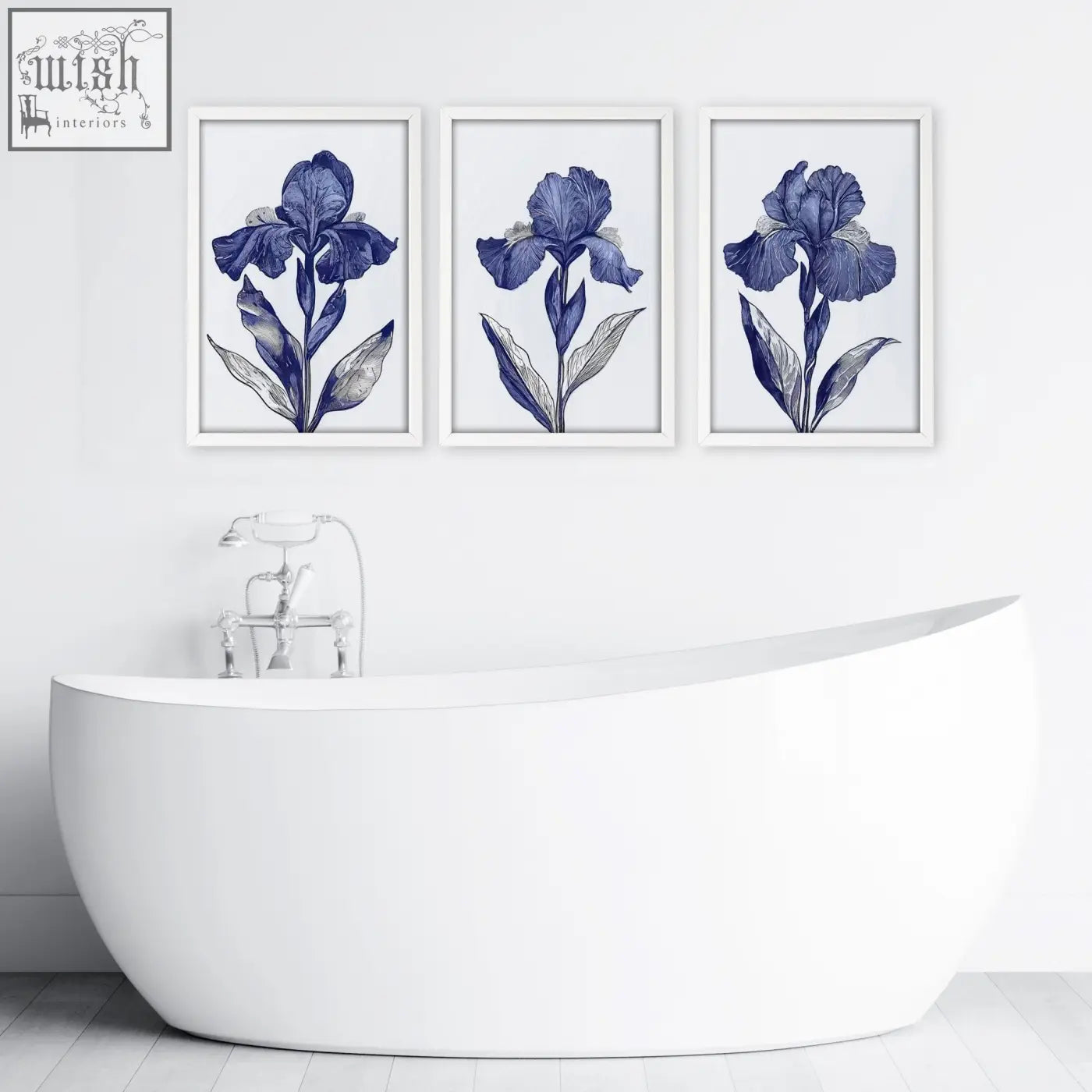 Three framed blue iris botanical wall art prints hang above a white freestanding bathtub in bathroom decor