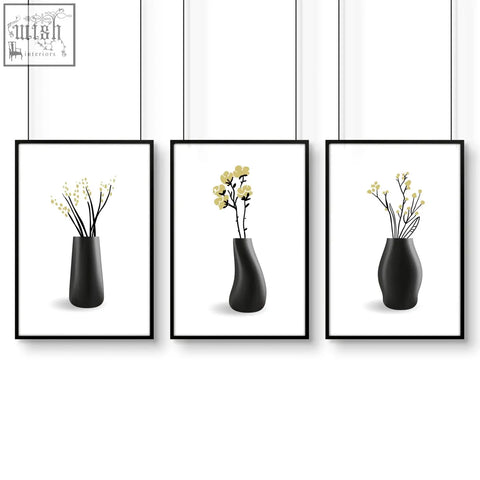 Set of three minimalist black ceramic vases with unique shapes and yellow blossoms for botanical wall art in bathroom walls