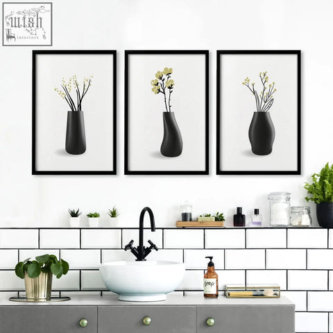 Set of three black framed botanical wall art prints with minimalist designs perfect for bathroom walls