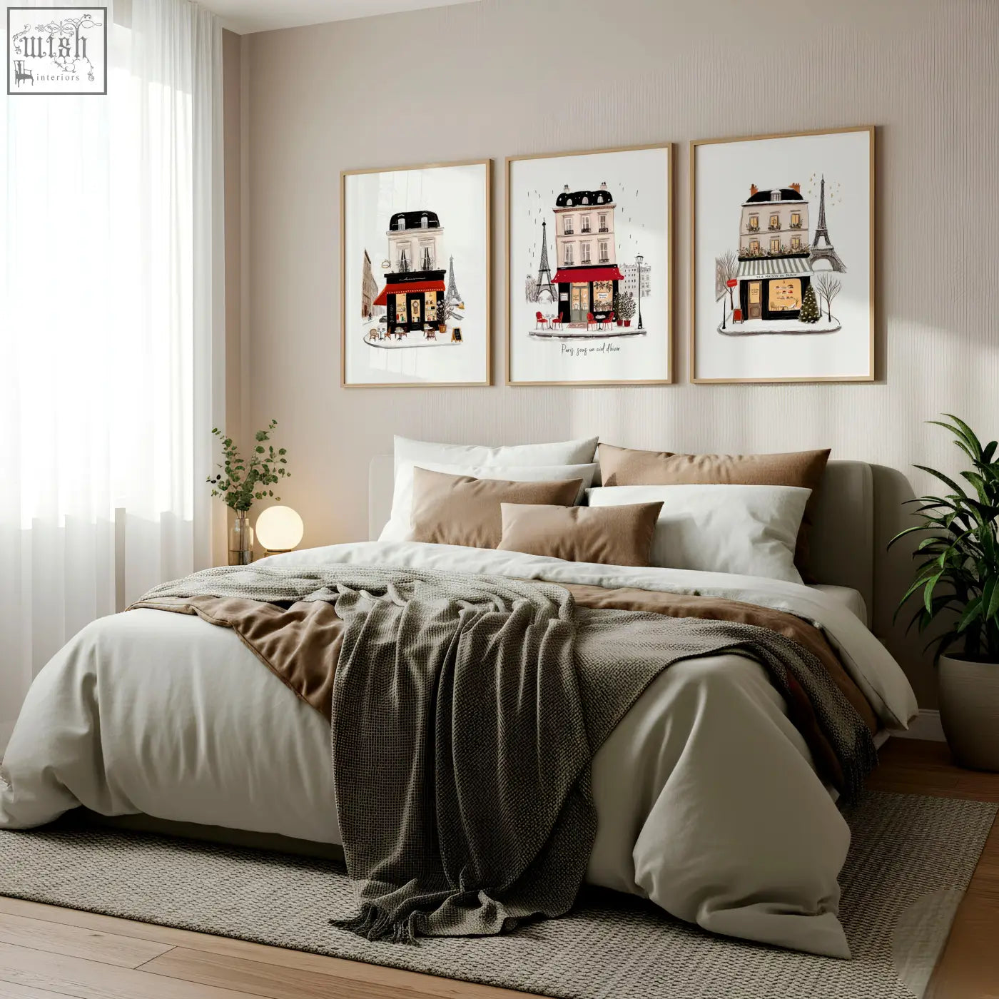 Three framed parisian-themed prints with maison du pain and paris sous designs hang above the beige bedroom wall