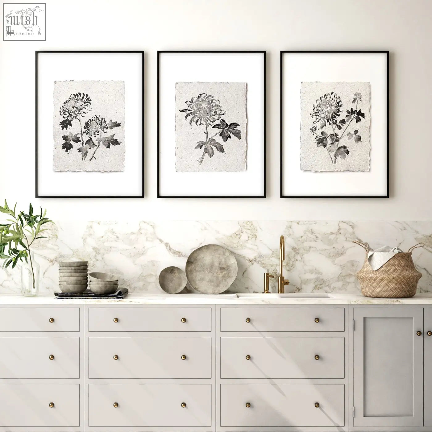 Three black-framed french country botanical chrysanthemum prints on textured beige paper above marble countertop wall art