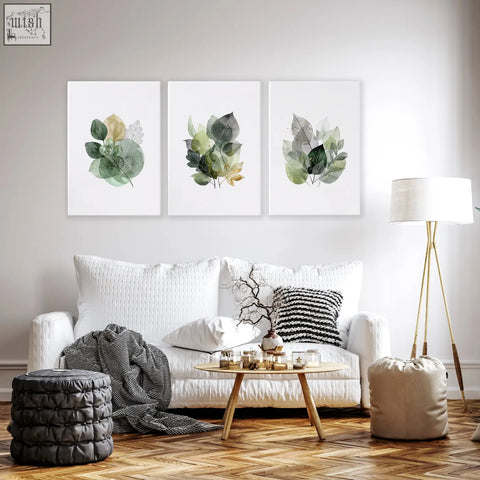 Set of three living room botanical prints with green and gold-tone watercolor leaves on white canvas