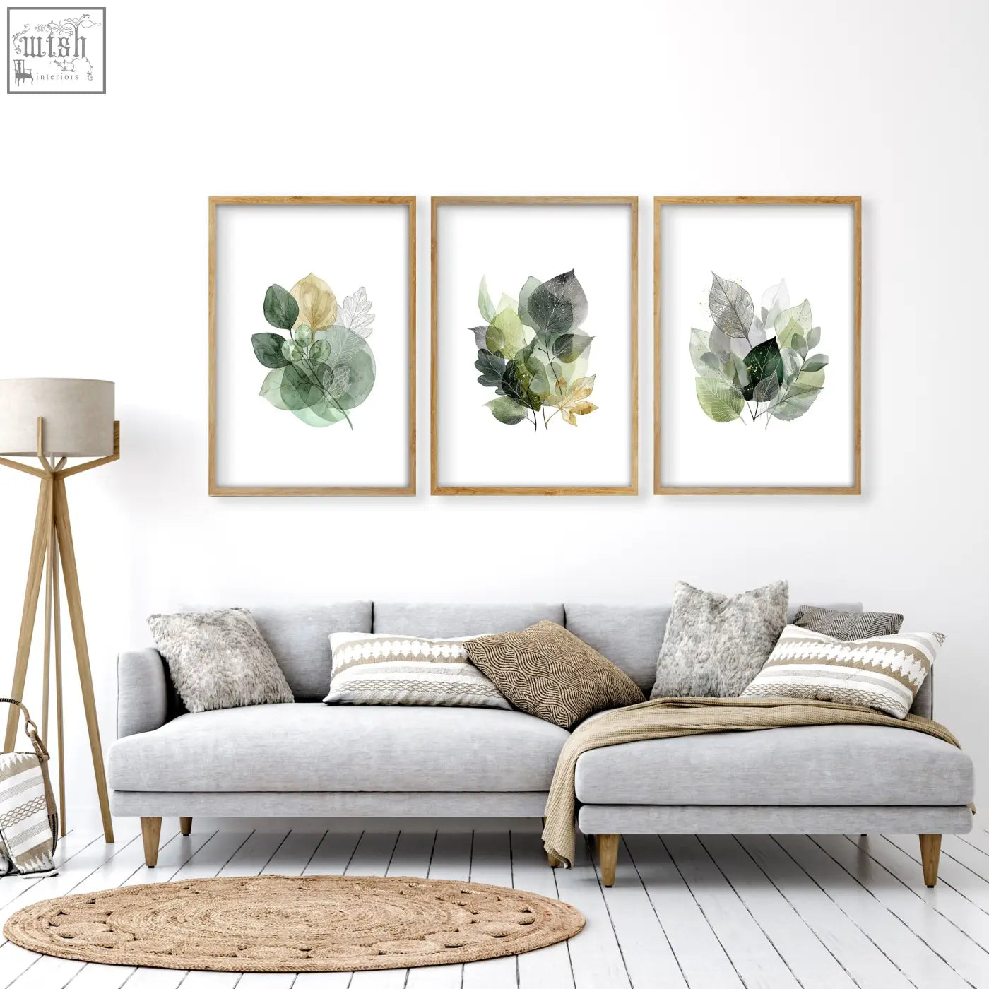 Three framed living room botanical prints with green and gold-tone watercolor leaves in light wood frames set of 3