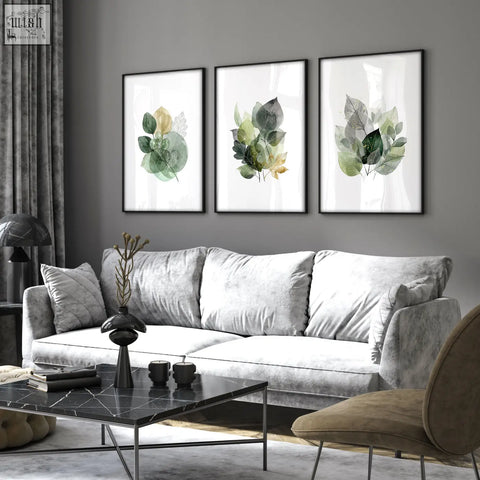 Set of three living room botanical prints with green and gold-tone watercolor leaves in black frames for room decoration