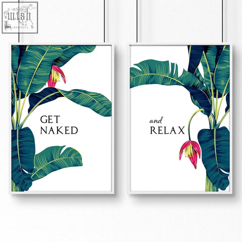 Pair of framed tropical wall art prints with bold green banana leaves and pink flowers for bathroom walls set of 2