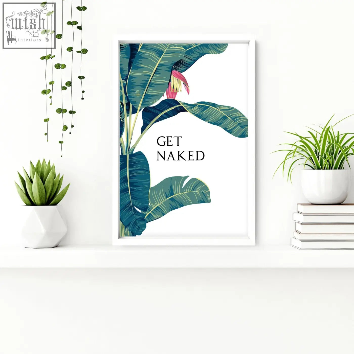 White-framed tropical wall art with teal banana leaf and pink flower featuring get naked text for bathroom walls