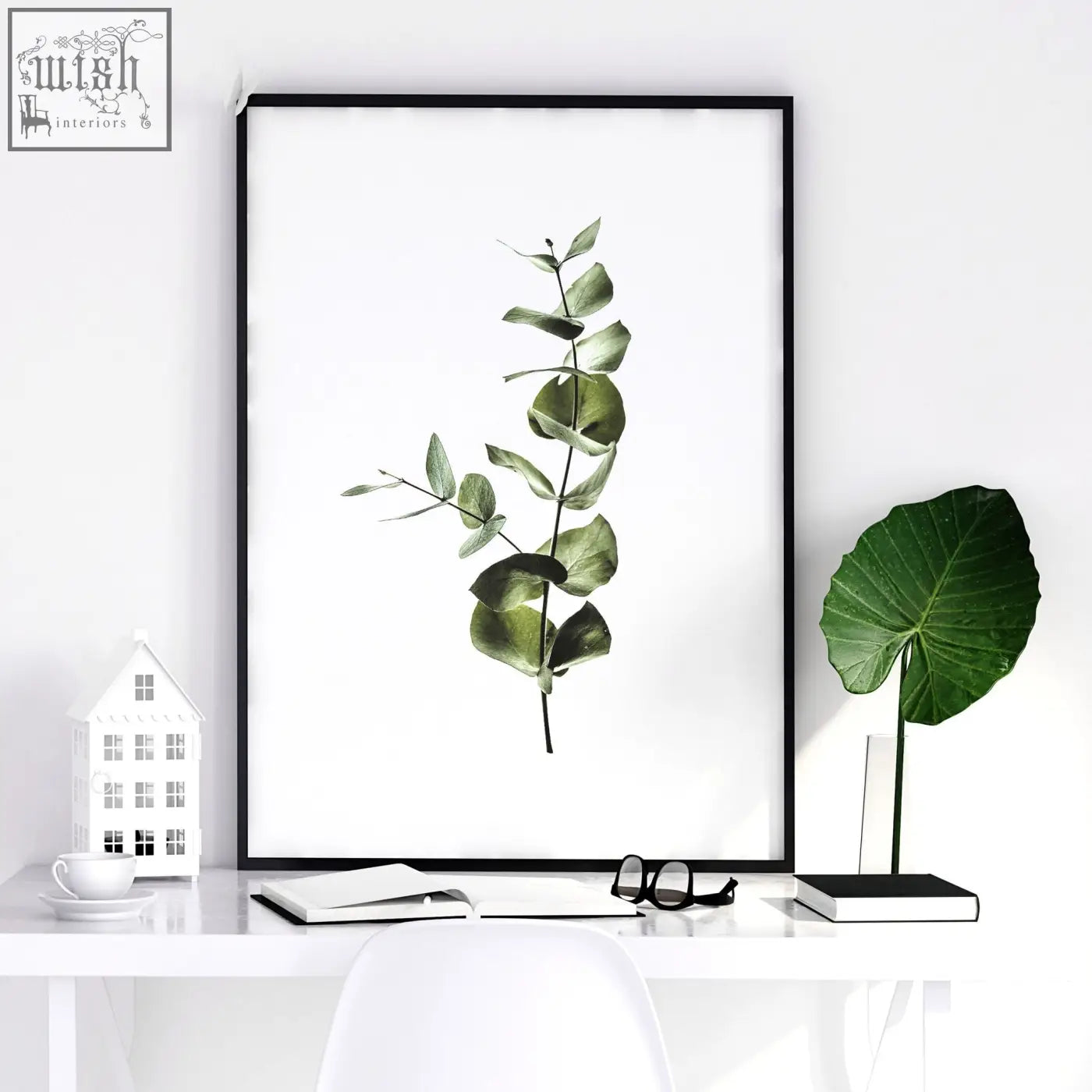 Black-framed wall art prints set of 2 featuring single eucalyptus branch with soft green leaves for kitchen decor