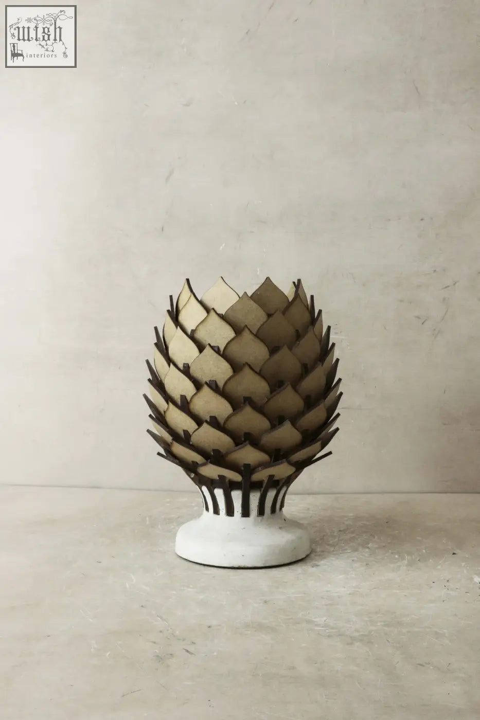 Beige and dark brown protea table lamp with layered pinecone design and white ceramic base for stylish lighting